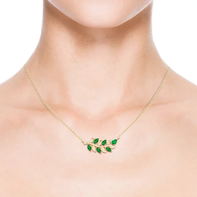 Emerald branch necklace in 14k yellow gold, featuring nature-inspired design by Irdoja Diamonds.