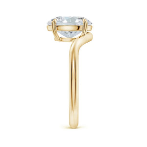 Solitaire oval lab-grown diamond engagement ring with a curved shank in 18K yellow gold by Irdoja Diamonds.