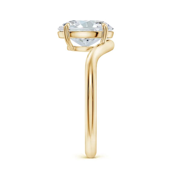 Solitaire oval lab-grown diamond engagement ring with a curved shank in 18K yellow gold by Irdoja Diamonds.