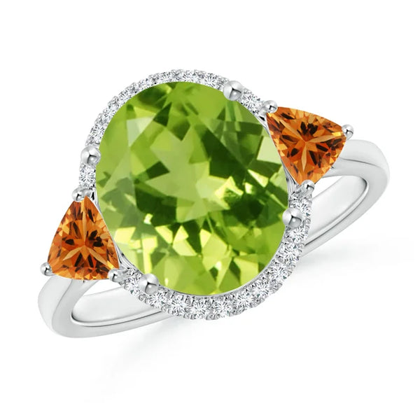 Oval peridot center stone with trillion citrine accents and diamond halo in 18k white gold ring by Irdoja Diamonds.