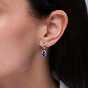 Pear blue sapphire drop earrings with diamond halo in 18K and 14K gold by Irdoja Diamonds.