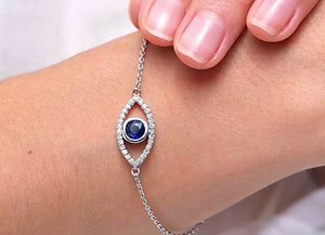 Bezel-Set Sapphire & Diamond Evil Eye Bracelet worn on wrist, featuring a blue sapphire and lab-grown diamond halo.