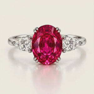 The Rose Tourmaline Ring turning, showing the oval pink tourmaline between two pear-cut lab diamonds