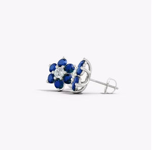 Lab-Grown Blue Sapphire & Diamond Flower Stud Earrings featuring blue sapphires and a white diamond in floral design.
