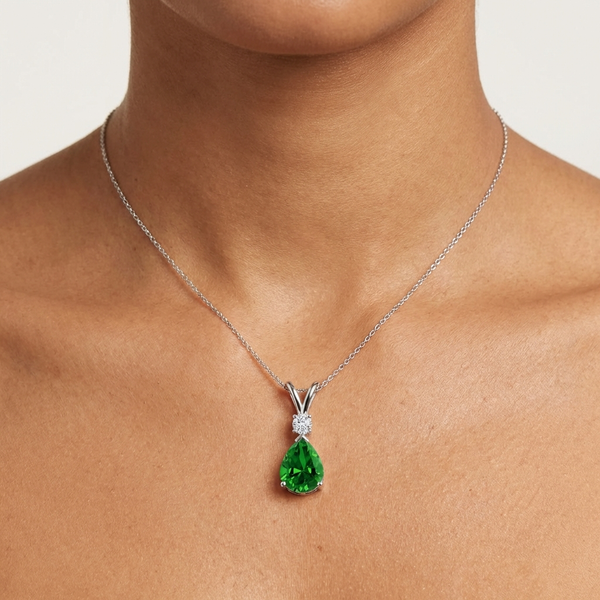 Prong-Set Lab-Grown Emerald Teardrop V-Bale Pendant with Diamond showcased on a model's neck.
