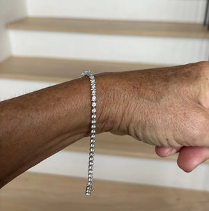 Prong-Set Round Lab-Grown Diamond Tennis Bracelet worn on a wrist, showcasing its sparkling diamonds and elegant design.