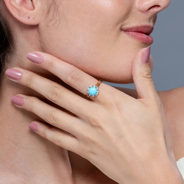 Round turquoise ring with triple split shank and alternating diamond halo in 18k yellow gold by Irdoja Diamonds.