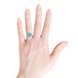Round turquoise ring with triple split shank and diamond halo in 18k yellow gold by Irdoja Diamonds.